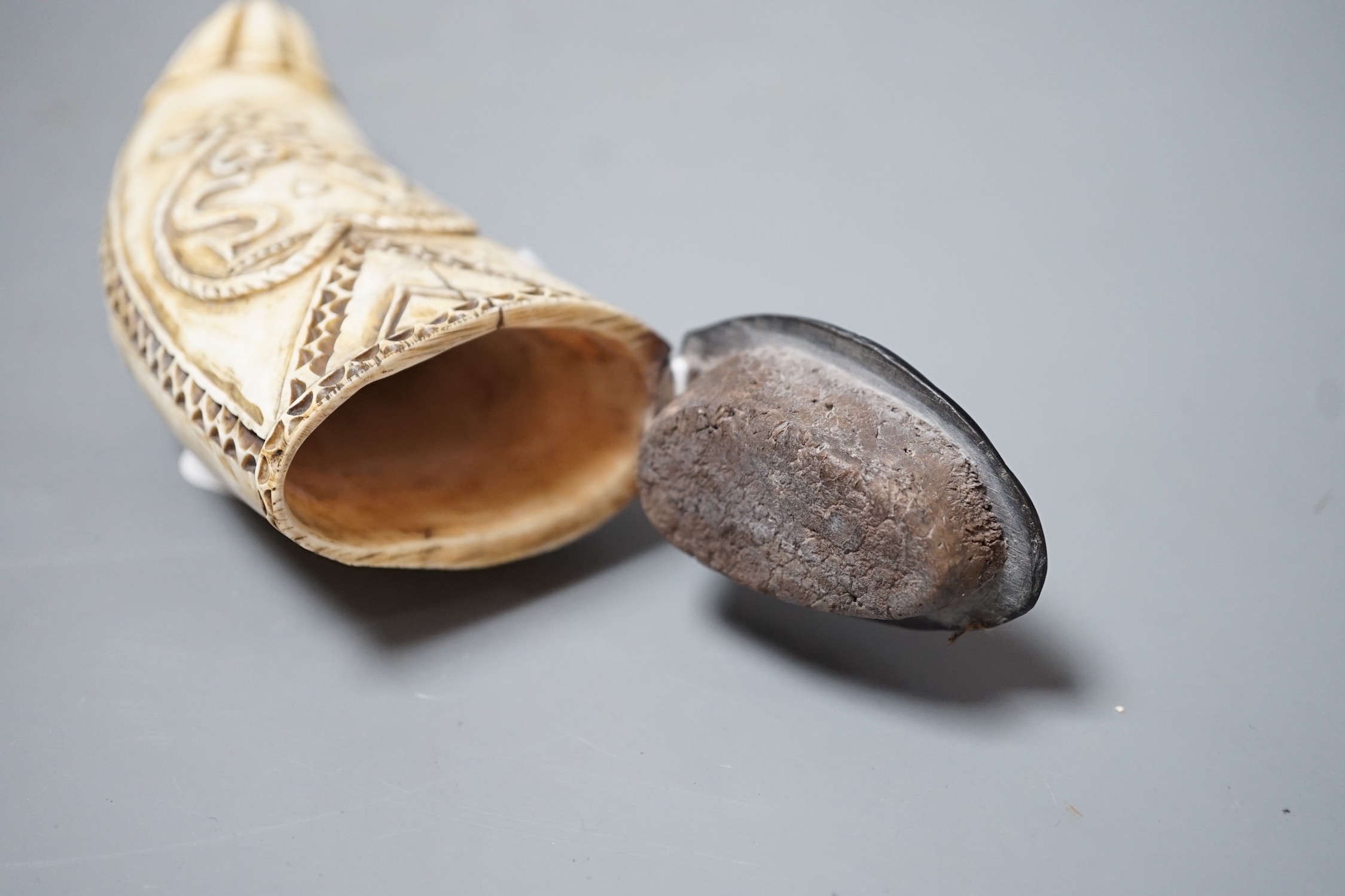 A worked scrimshaw depicting an erotic female fruit seller, dated 1862 to reverse, with a shell carved baleen hinged lid. 13cm long